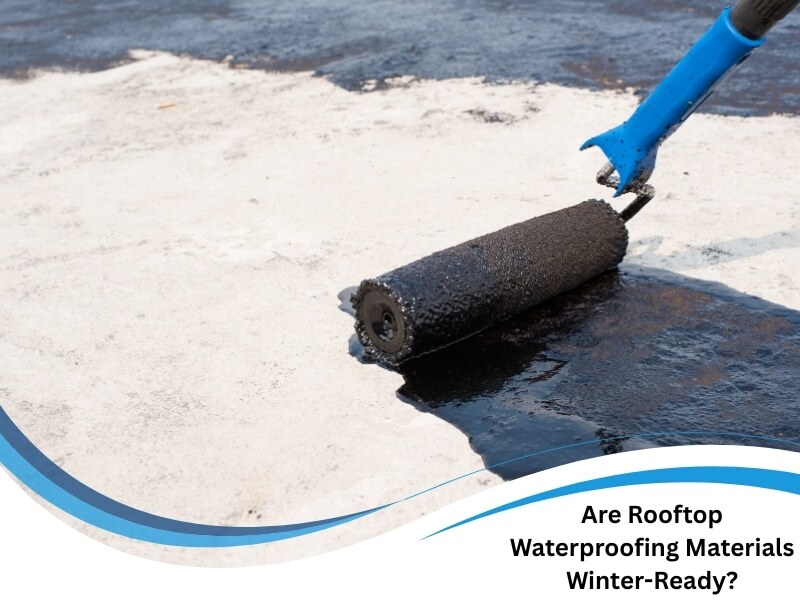 Worker using roller to apply rooftop waterproofing materials over concrete surface for winter protection