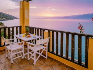 Oceanview balcony with wooden railing, highlighting where water damage may cause a leaky balcony. 